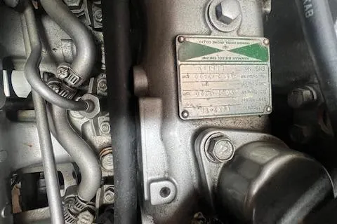 Slide: The Image of Close-up of a 2003 Catalina 470 Sloop engine components and identification plate. - 37