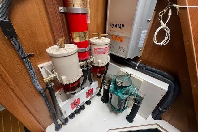 Slide: The Image of Engine room of 2003 Catalina 470 Sloop with wing keel, featuring fuel filters and electrical panel. - 39