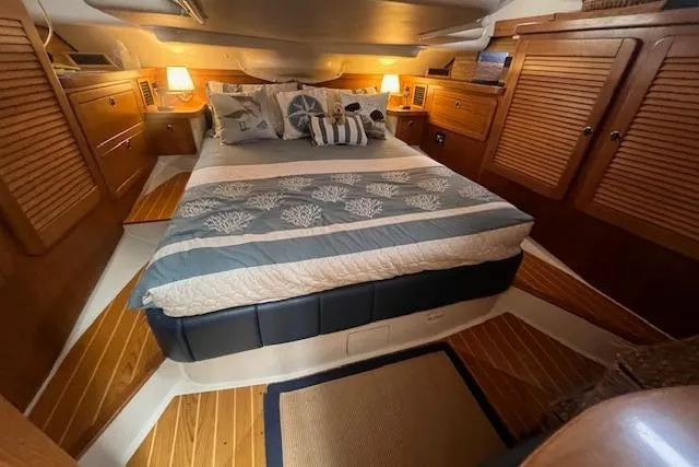 Slide: The Image of Luxurious 2003 Catalina 470 Sloop cabin with cozy bed and elegant wood finish. - 41
