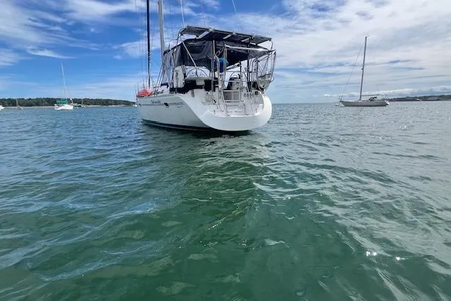 Slide: The Image of Catalina 470 Sloop with Wing Keel, 2003, anchored in calm waters under a blue sky. - 48