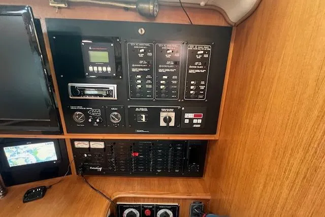 Slide: The Image of Control panel of a 2003 Catalina 470 Sloop with Wing Keel, featuring navigation and electrical systems. - 7