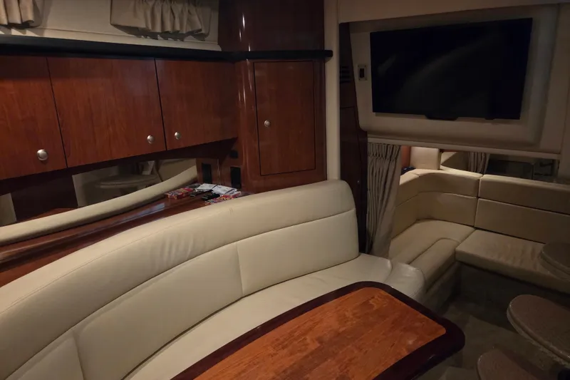 Slide: The Image of Interior of 2007 Sea Ray 320 Sundancer with leather seating and wooden cabinetry. - 13