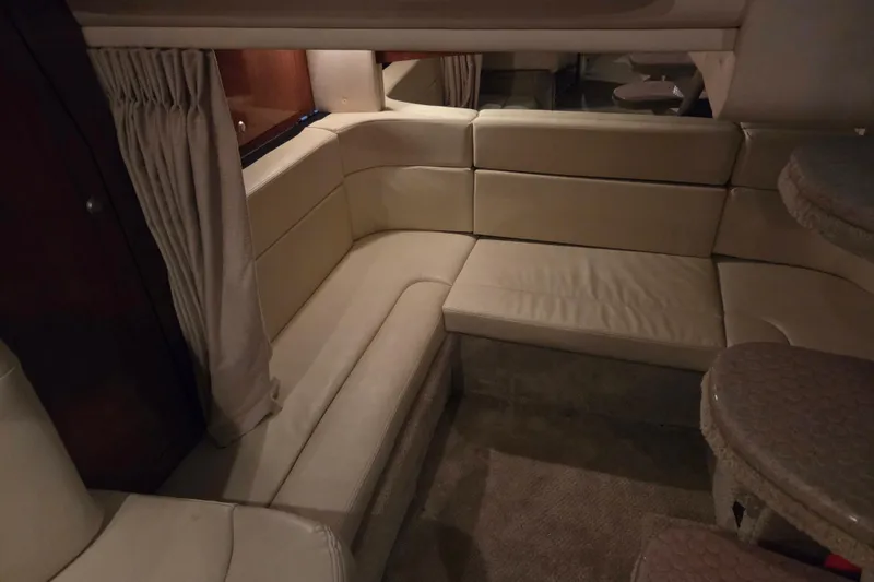 Slide: The Image of Interior of 2007 Sea Ray 320 Sundancer with beige seating and curtains. - 16