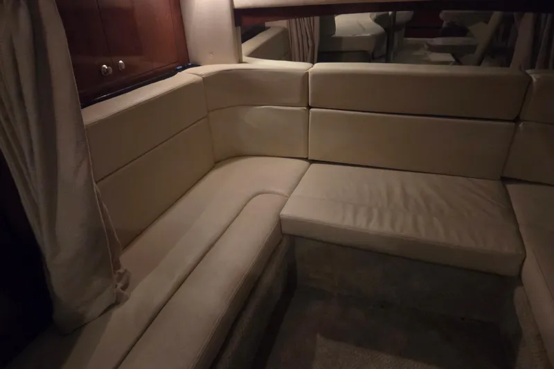 Slide: The Image of Interior seating area of 2007 Sea Ray 320 Sundancer with beige upholstery. - 17