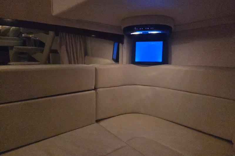 Slide: The Image of Interior of 2007 Sea Ray 320 Sundancer with beige seating and a small TV screen. - 18