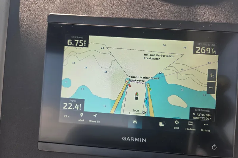 Slide: The Image of Garmin GPS display on 2007 Sea Ray 320 Sundancer, showing Holland Harbor navigation details. - 21
