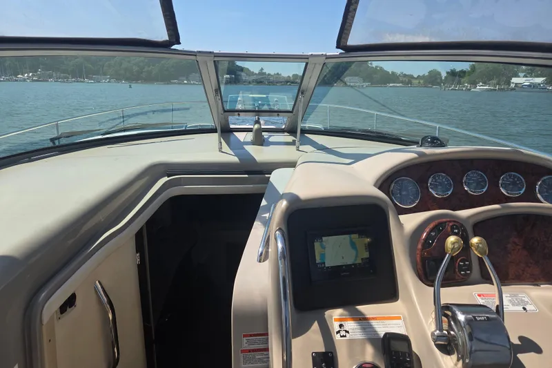 Slide: The Image of 2007 Sea Ray 320 Sundancer helm with navigation controls, gauges, and water view. - 4