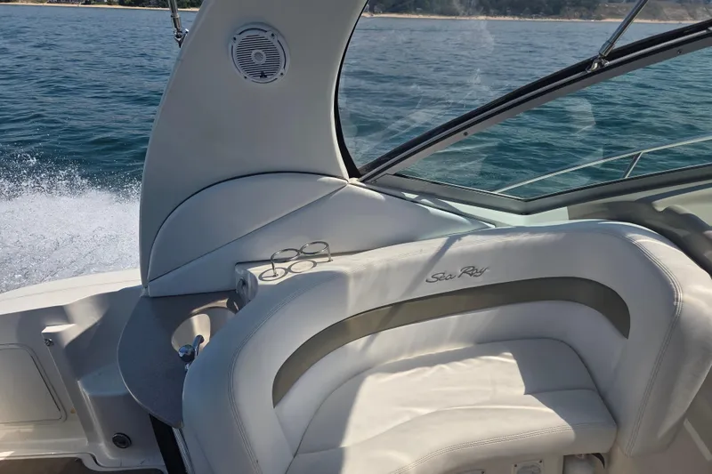 Slide: The Image of 2007 Sea Ray 320 Sundancer boat interior with white seating and ocean view. - 7