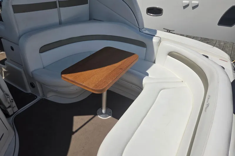 Slide: The Image of 2007 Sea Ray 320 Sundancer interior with white seating and wooden table. - 8