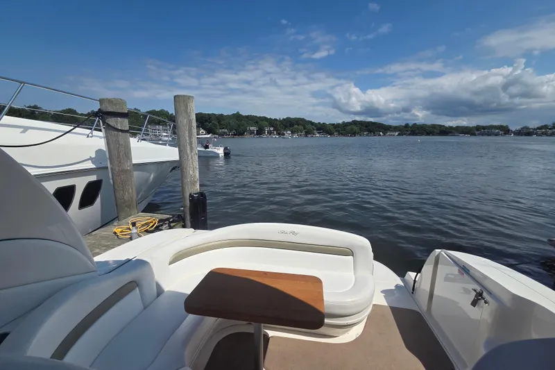 Slide: The Image of 2007 Sea Ray 320 Sundancer docked, featuring a spacious seating area with scenic water view. - 9