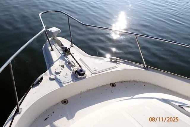 Slide: The Image of Bow of 2003 Sea Ray Sundancer 460 yacht on calm water, sunlight reflecting. - 10