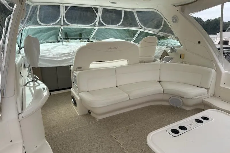 Slide: The Image of 2003 Sea Ray Sundancer 460 interior with white seating and panoramic windows. - 11