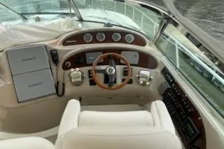 Slide: The Image of 2003 Sea Ray Sundancer 460 helm with gauges, steering wheel, and controls. - 12