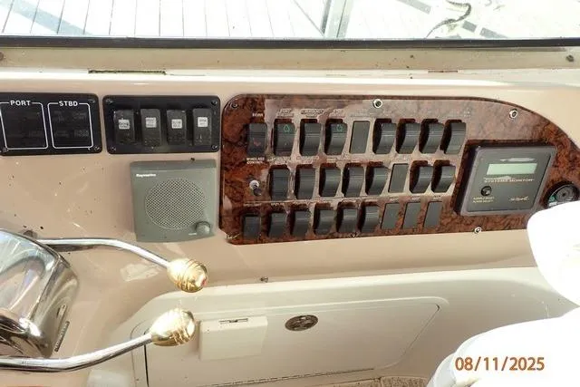 Slide: The Image of Control panel of a 2003 Sea Ray Sundancer 460 yacht with switches and gauges. - 13