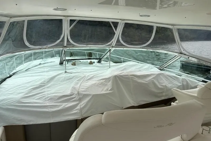 Slide: The Image of Interior view of 2003 Sea Ray Sundancer 460 yacht with covered deck and water backdrop. - 16