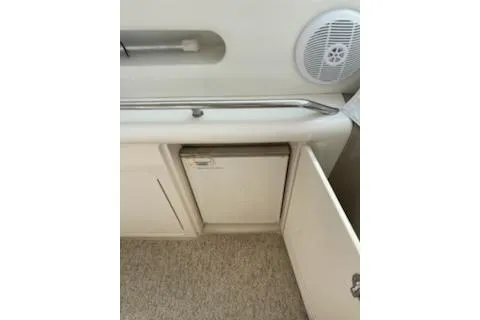 Slide: The Image of 2003 Sea Ray Sundancer 460 interior with speaker and storage cabinet. - 19