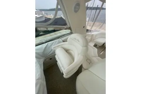 Slide: The Image of 2003 Sea Ray Sundancer 460 interior with white leather seating and waterfront view. - 25