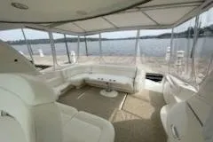 Slide: The Image of 2003 Sea Ray Sundancer 460 yacht interior with white seating and panoramic water views. - 27