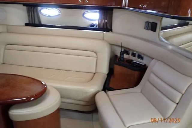Slide: The Image of Luxurious interior of 2003 Sea Ray Sundancer 460 yacht with beige seating and wooden accents. - 28