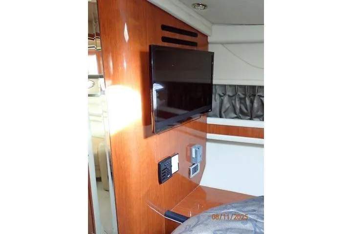 Slide: The Image of Interior of 2003 Sea Ray Sundancer 460 with mounted TV and wooden paneling. - 30
