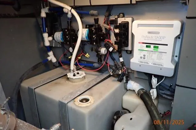 Slide: The Image of Engine room of a 2003 Sea Ray Sundancer 460 with electrical and plumbing systems. - 44