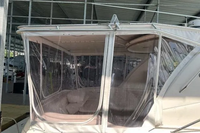 Slide: The Image of 2003 Sea Ray Sundancer 460 with enclosed cockpit under marina shelter. - 49