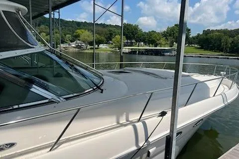 Slide: The Image of 2003 Sea Ray Sundancer 460 yacht docked by a scenic lakeside. - 50