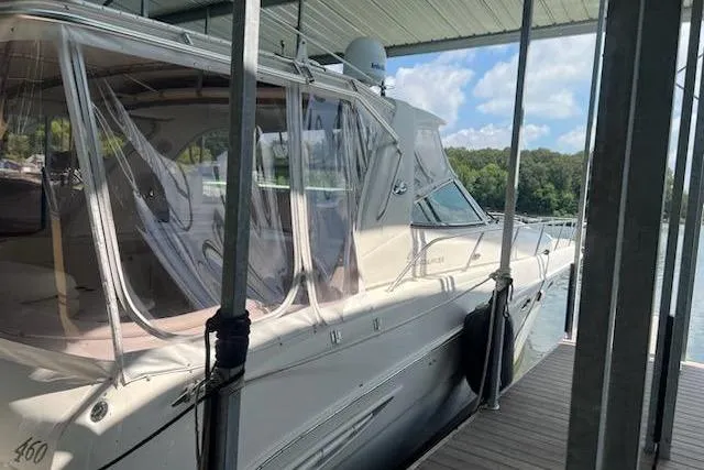 Slide: The Image of 2003 Sea Ray Sundancer 460 docked under a covered marina with clear skies. - 51