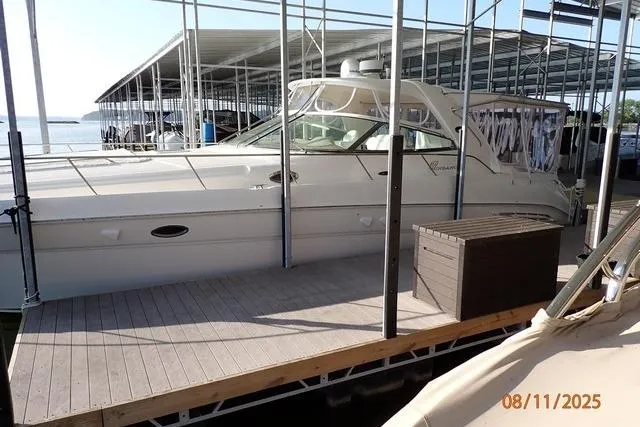 Slide: The Image of 2003 Sea Ray Sundancer 460 docked in a marina under a covered structure. - 7