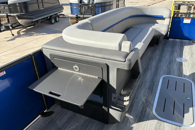 Slide: The Image of 2026 Bennington 26 MCSB boat interior with gray seating and storage compartment. - 22