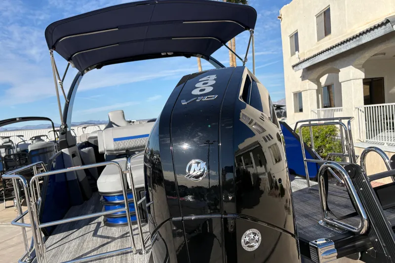 Slide: The Image of 2026 Bennington 26 MCSB pontoon boat with powerful V10 engine, docked under clear skies. - 6