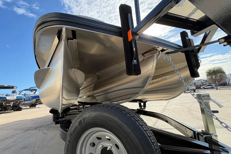 Slide: The Image of 2026 Bennington 26 MCSB pontoon boat on trailer, showcasing sleek aluminum hull design. - 7