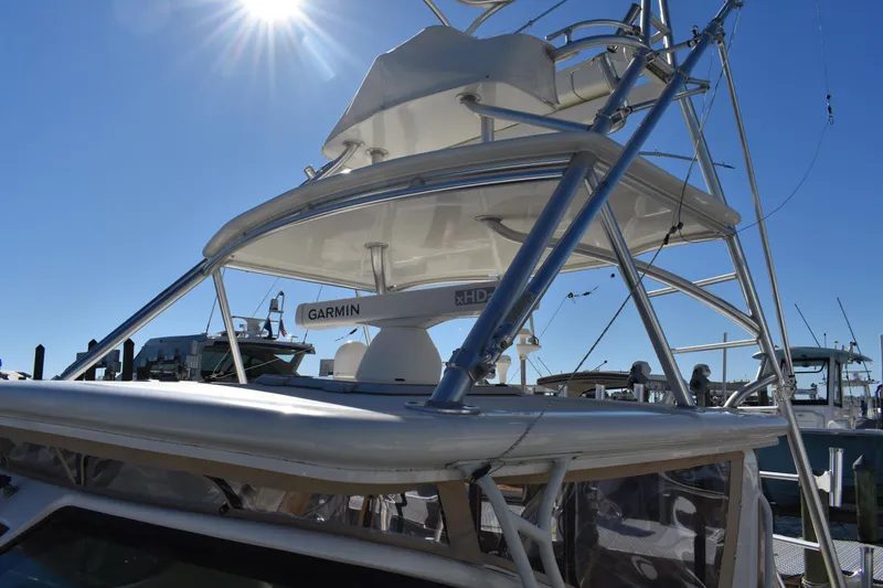 Slide: The Image of 2008 Tiara Sport Fish boat with tower and Garmin radar under clear blue sky. - 10