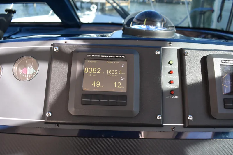 Slide: The Image of Dashboard of a 2008 Tiara Sport Fish boat with digital display and compass. - 17