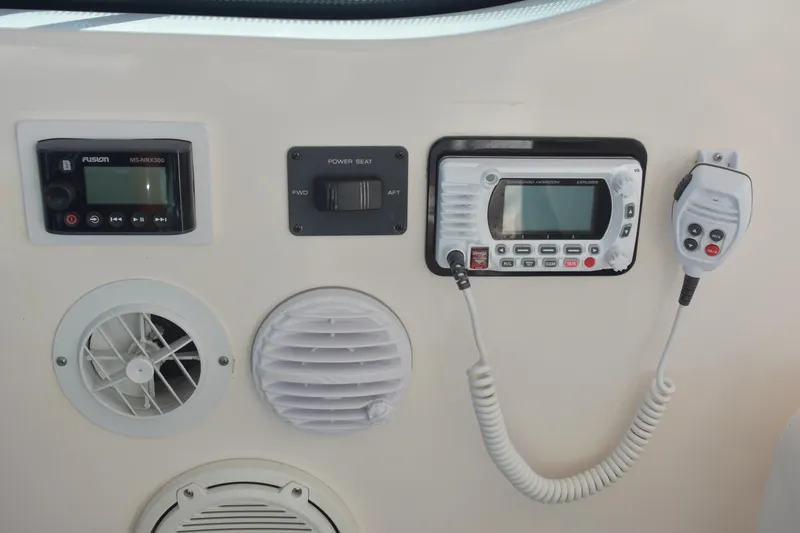 Slide: The Image of 2008 Tiara Sport Fish boat dashboard with radio and ventilation controls. - 19