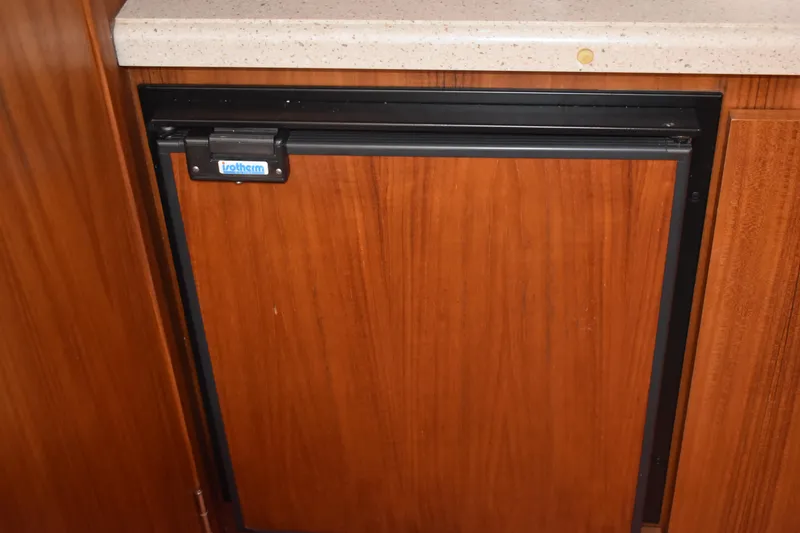 Slide: The Image of Wood-paneled refrigerator in 2008 Tiara Sport Fish boat interior. - 29