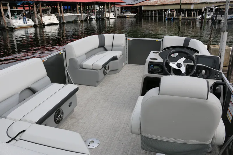 Slide: The Image of Interior of 2025 SunCatcher Select 18C pontoon boat with modern seating and steering console. - 4