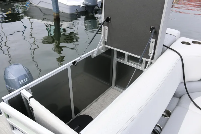 Slide: The Image of 2025 SunCatcher Select 18C boat with open storage compartment and visible motor. - 6