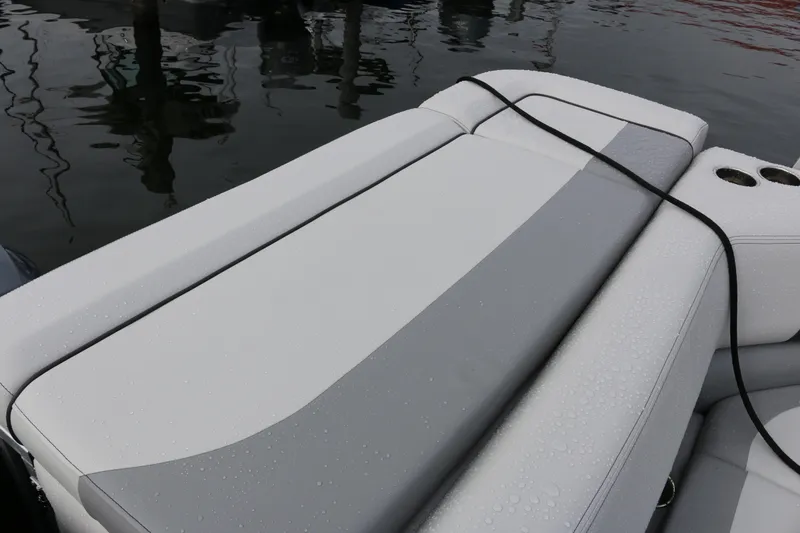 Slide: The Image of 2025 SunCatcher Select 18C boat with sleek, wet seating and cup holders by the water. - 7