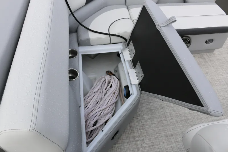 Slide: The Image of Open storage compartment on 2025 SunCatcher Select 18C boat with rope inside. - 9