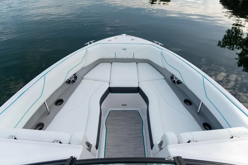 Slide: The Image of 2025 Regal LS4 boat interior with white seating, docked by a waterfront. - 13