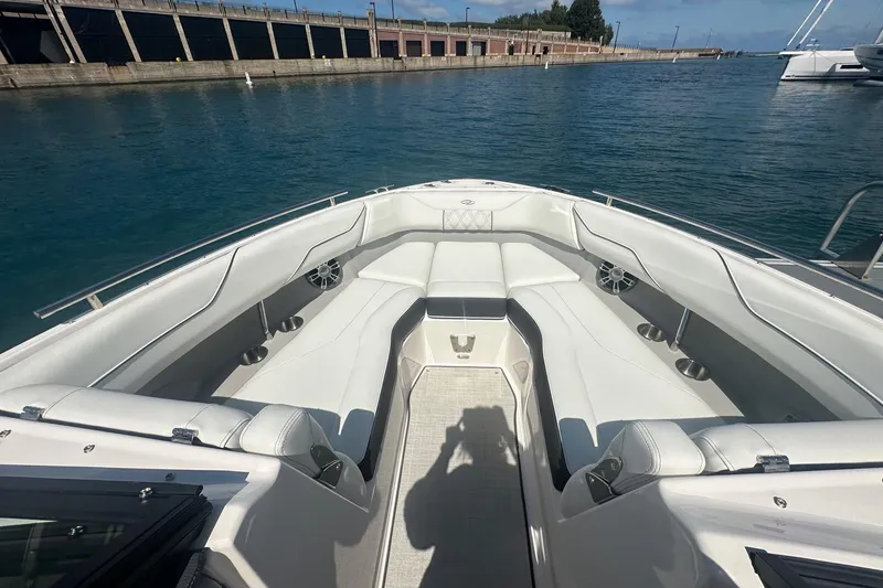 Slide: The Image of 2025 Regal LS4 boat interior with white seating, wooden table, and price tag of $129,900. - 5