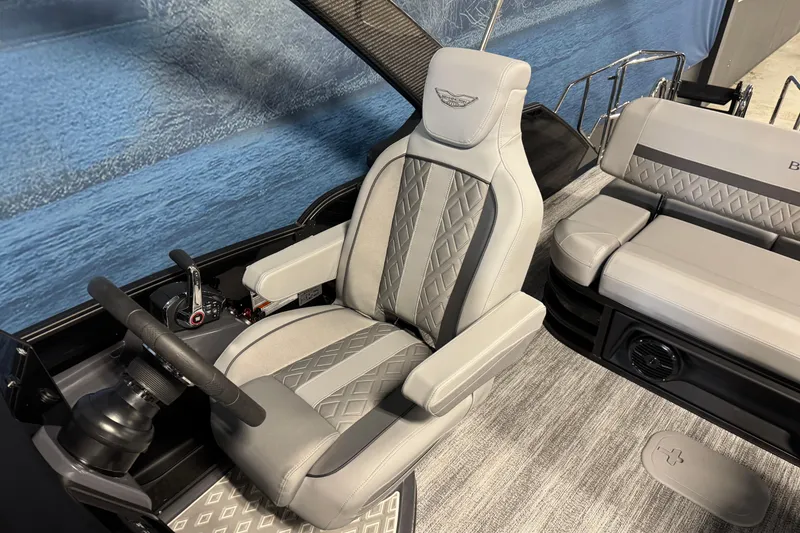Slide: The Image of Captain's seat of 2026 Bennington 26 MCSB boat with luxurious gray upholstery. - 11