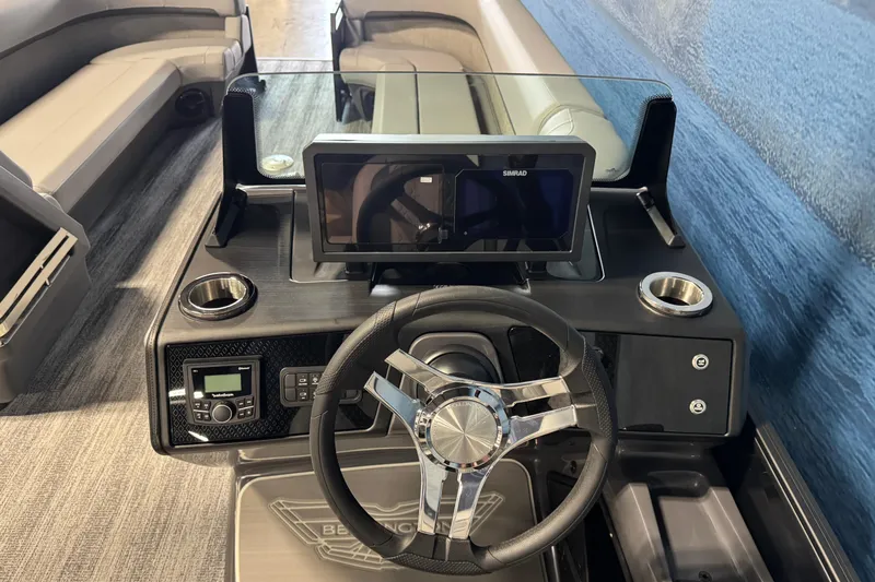 Slide: The Image of 2026 Bennington 26 MCSB boat dashboard with steering wheel and navigation display. - 12