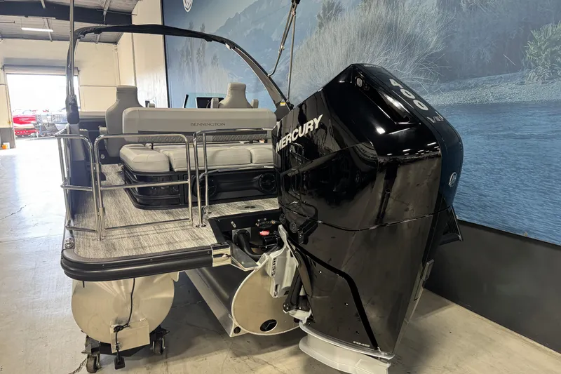 Slide: The Image of 2026 Bennington 26 MCSB pontoon boat with Mercury 400 outboard engine in showroom. - 4