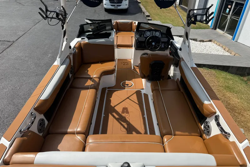 Slide: The Image of 2021 Axis T23 boat interior with tan seating and modern dashboard. - 10