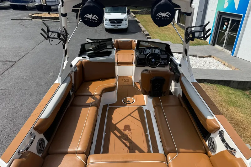 Slide: The Image of 2021 Axis T23 boat interior with tan seating and modern dashboard. - 11