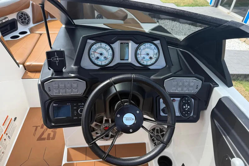 Slide: The Image of 2021 Axis T23 boat dashboard with steering wheel, gauges, and control panels. - 14