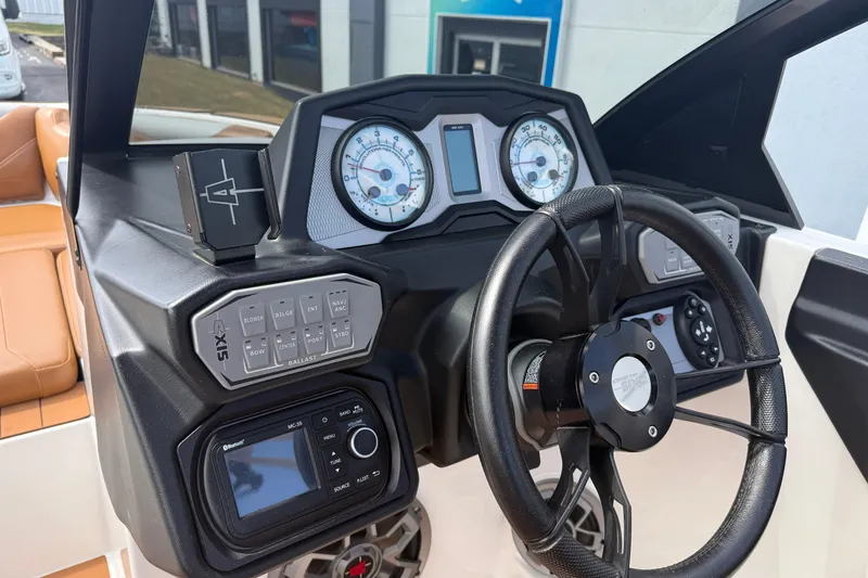 Slide: The Image of 2021 Axis T23 boat dashboard with steering wheel, gauges, and control panel. - 15