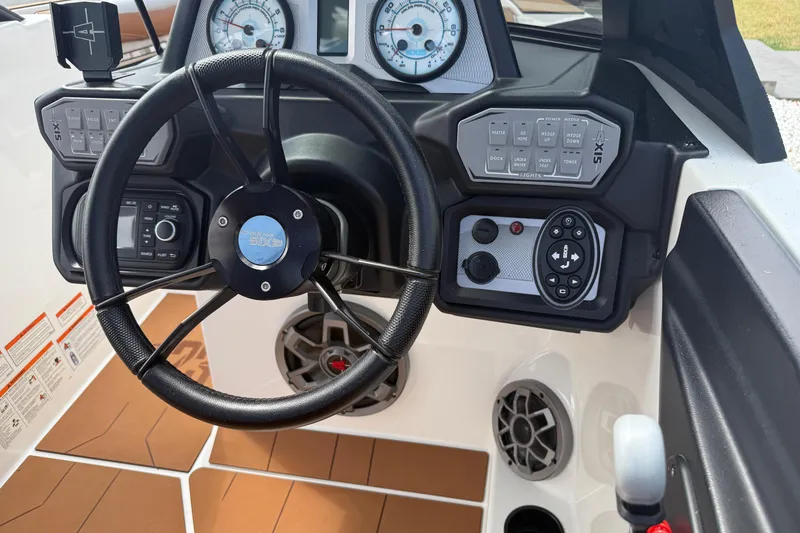 Slide: The Image of Steering wheel and dashboard of 2021 Axis T23 boat with control panels and gauges. - 16